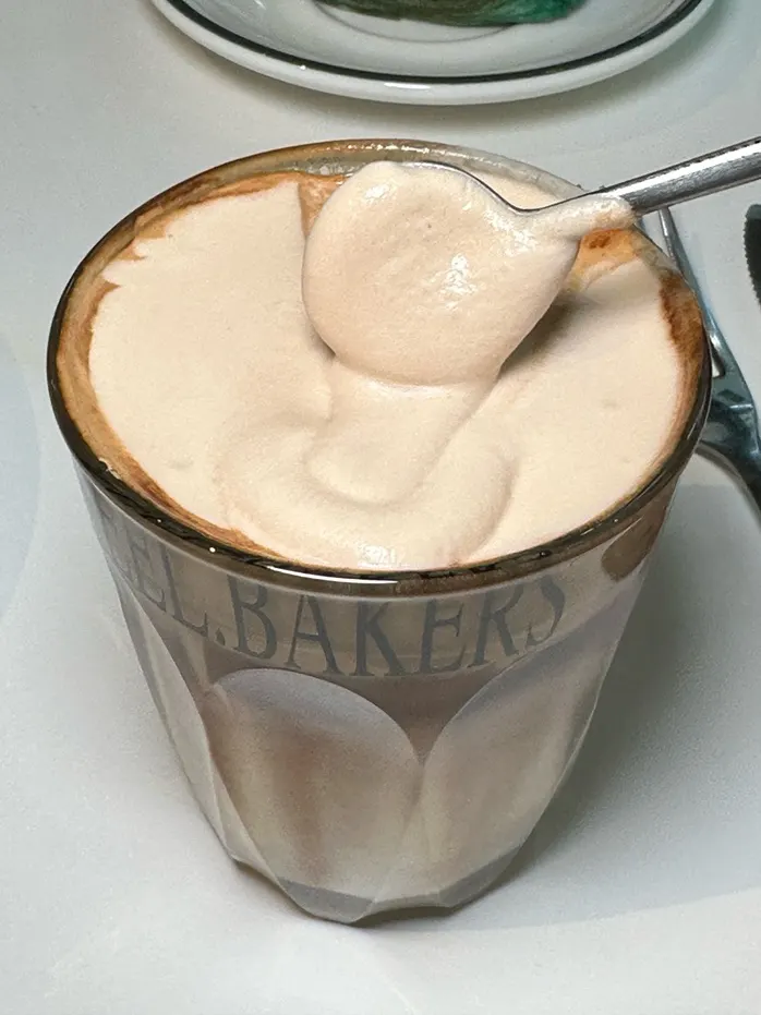 Signature reel latte with a thick layer of cream on top
