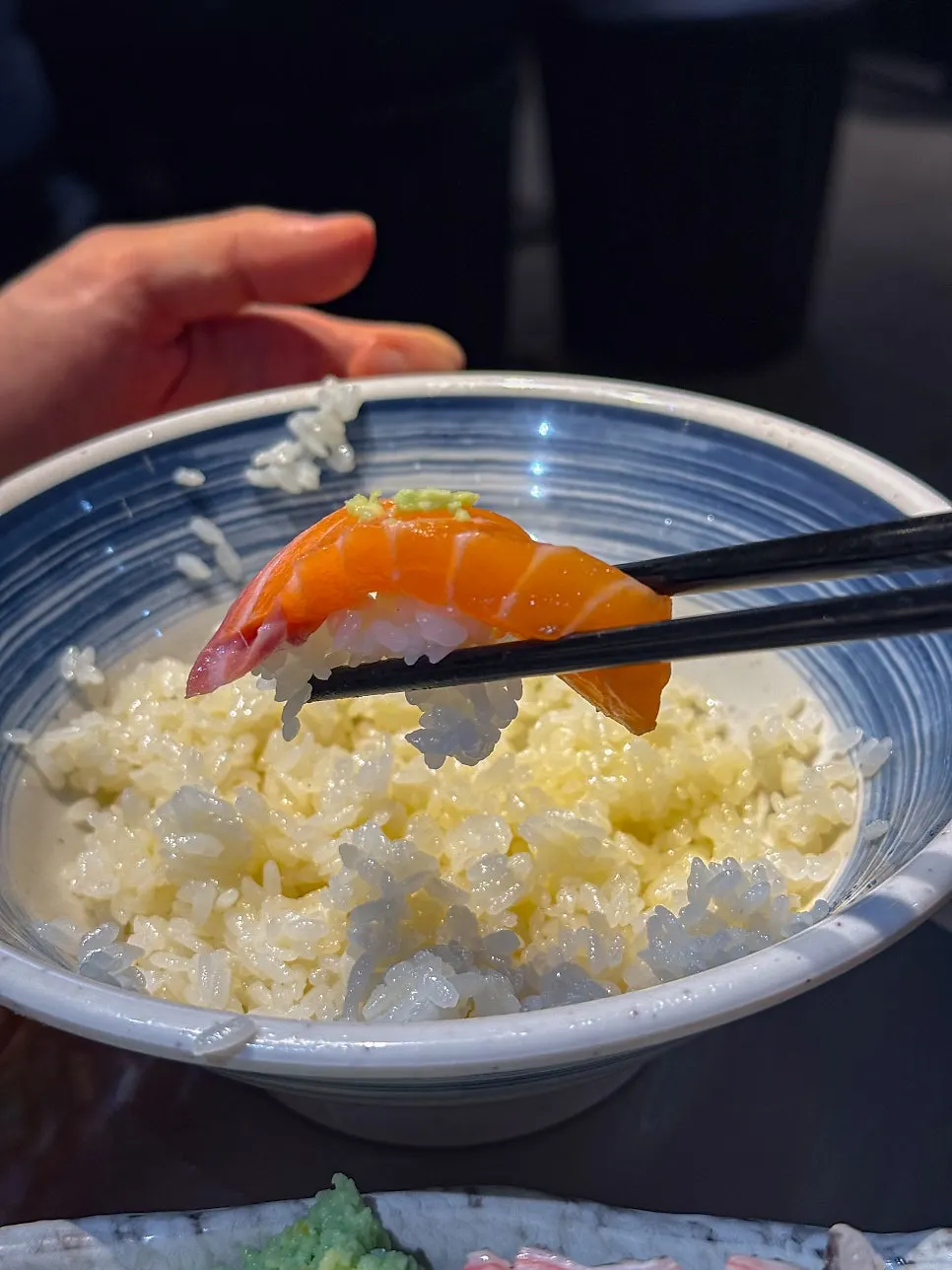 Picking up a piece of sashimi