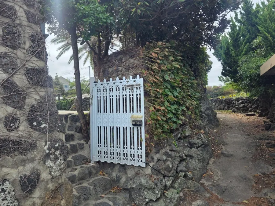 Café exterior blending modern stone with Jeju stone walls