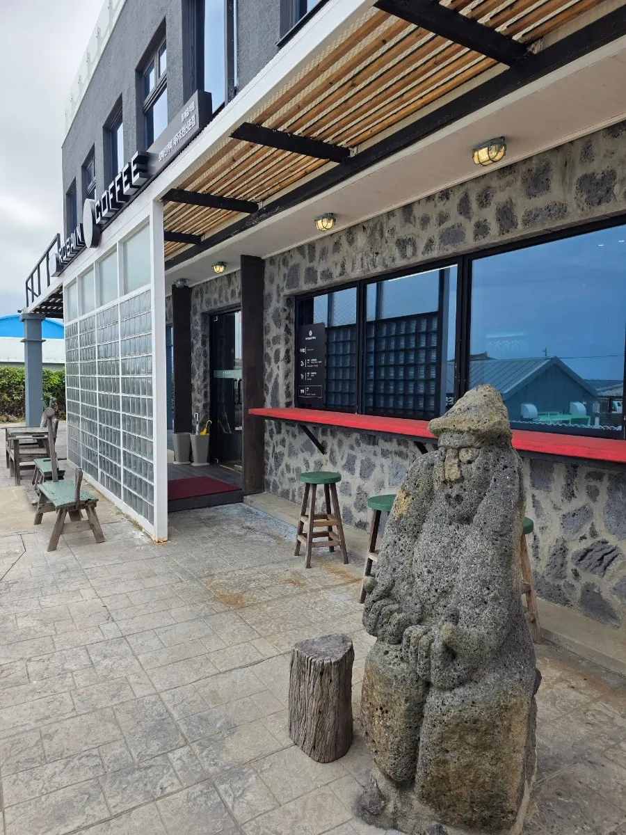 Café entrance with a dol hareubang stone statue