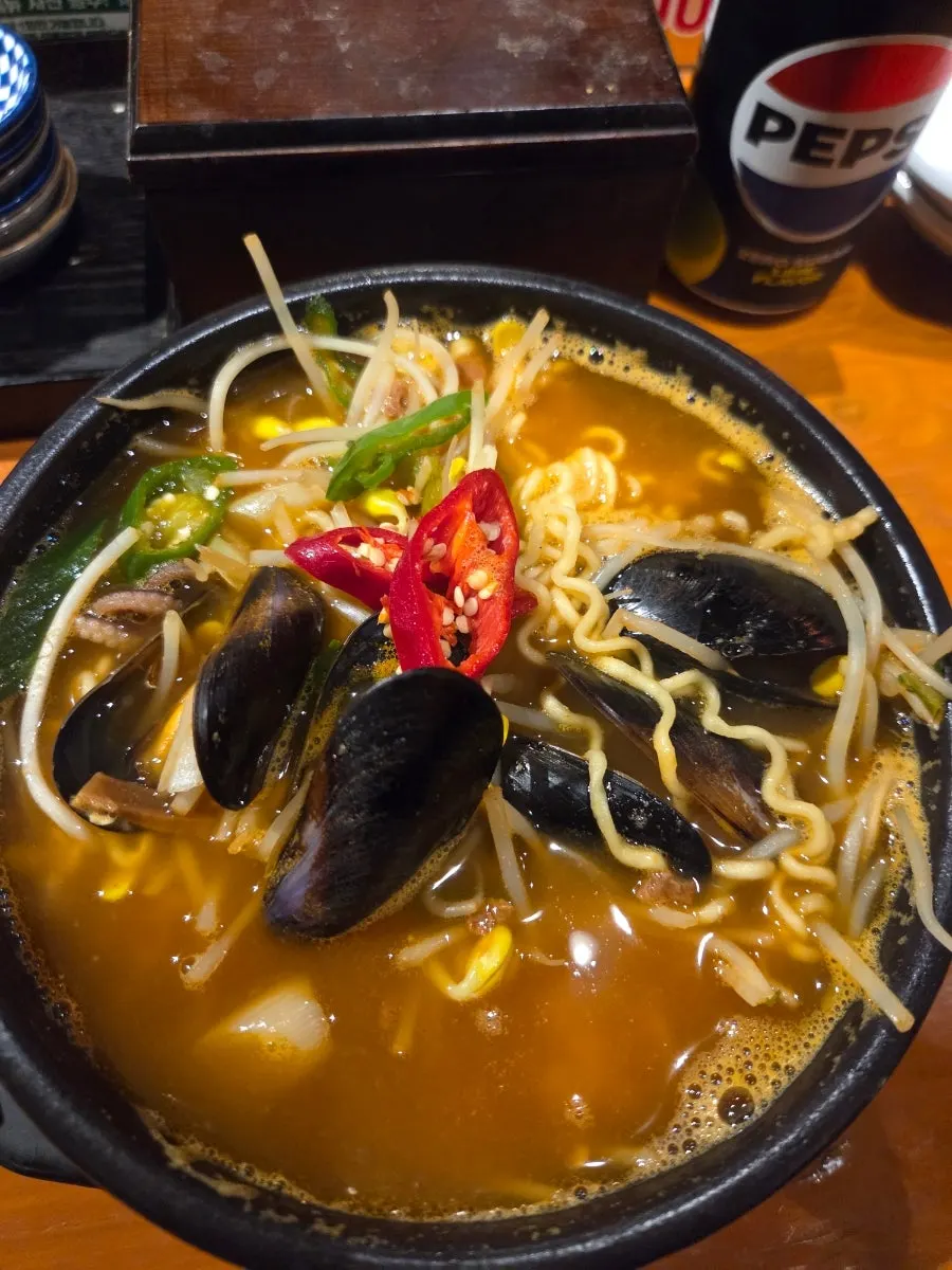 A bowl of seafood ramyeon packed with seafood