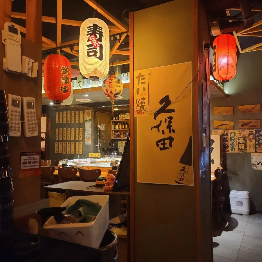 Cozy seating under warm izakaya lighting