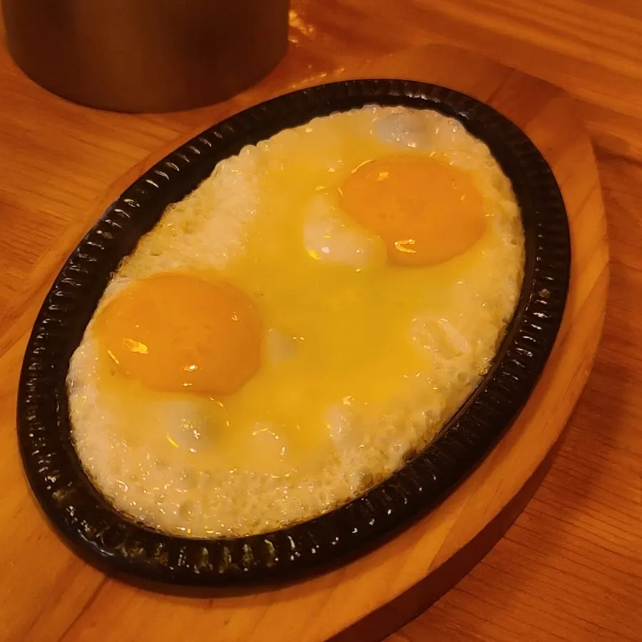 Pan-fried egg served on a hot plate as basic side dish