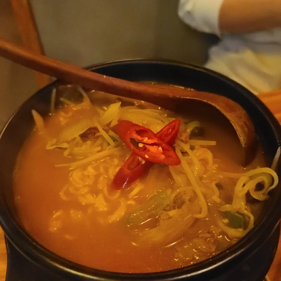 Spicy ramyeon boiling in an earthenware pot