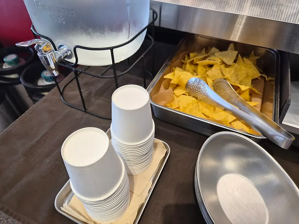 Self-serve bar with water, house-made nachos, and small plates