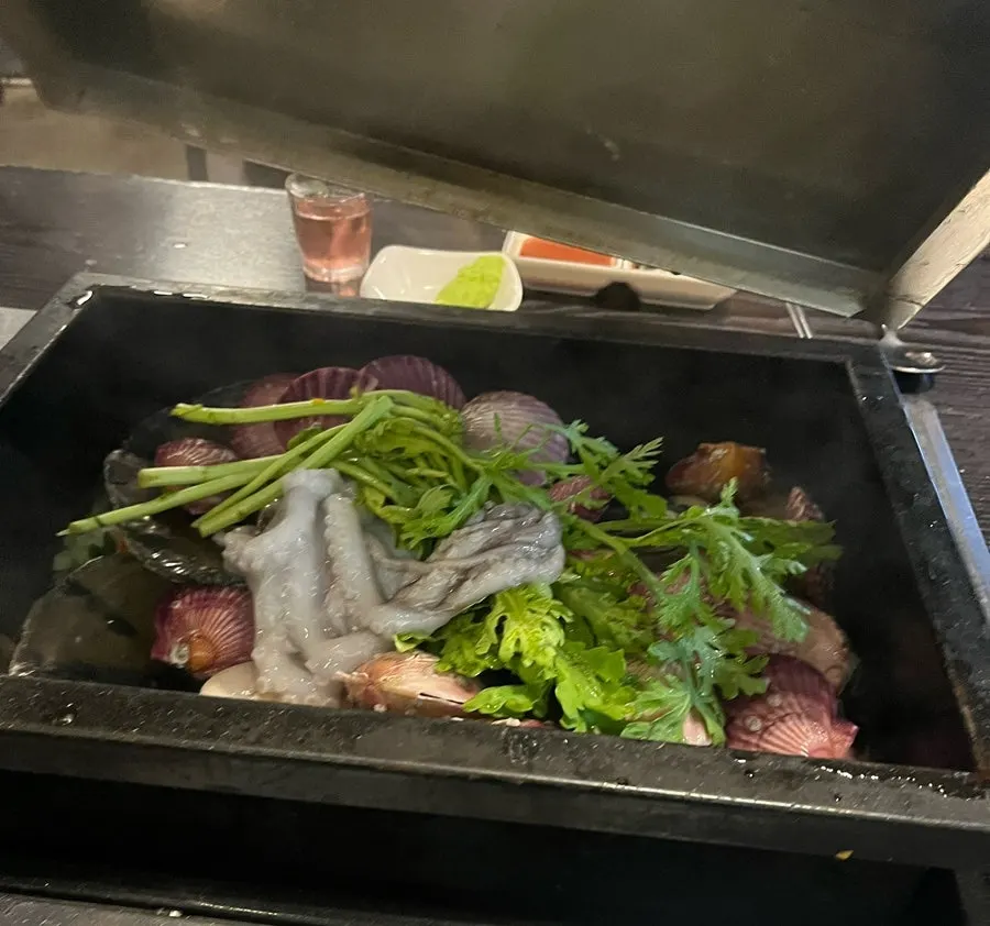 A generously set table of Loco Loco steamed clams