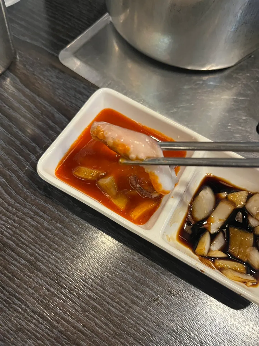 A glass of Saero Omija with the steamed clam snack