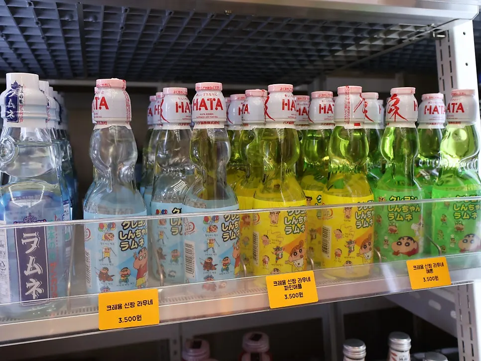 Wall-mounted fridge stocked with imported drinks