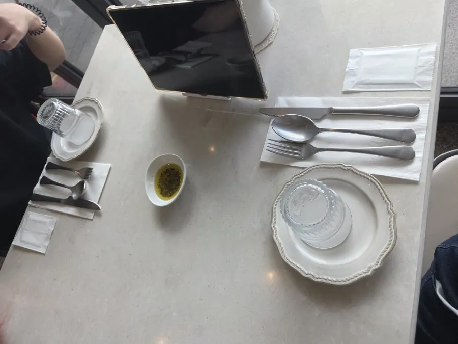 Table set with plates, water glass, and cutlery