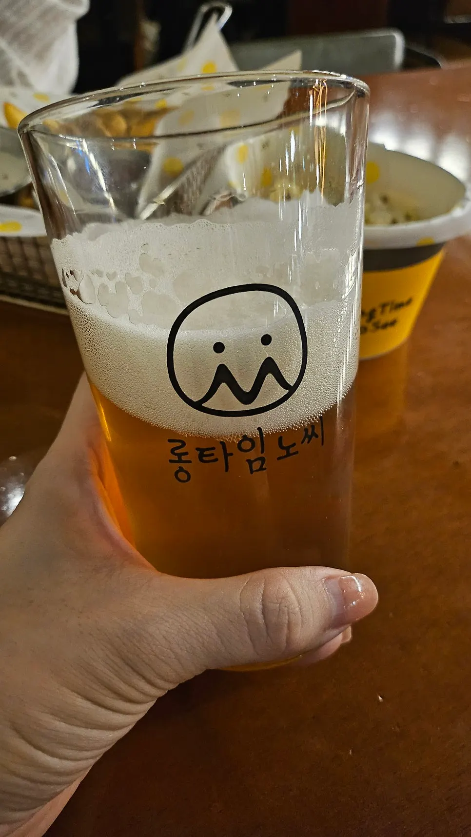 A self-tap beer glass with a lot of foam on top