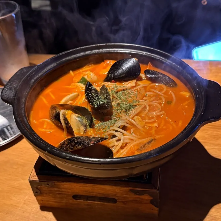 Spicy hangover-cure pasta set on a mini burner