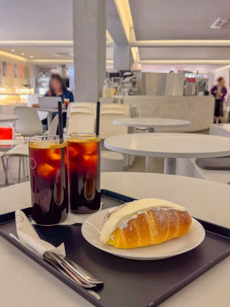 Cream salt bread and americano on the table