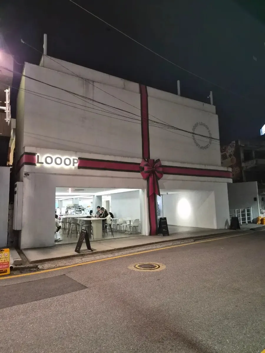 LOOOP café exterior in Seongsu-dong with a striking red ribbon decoration