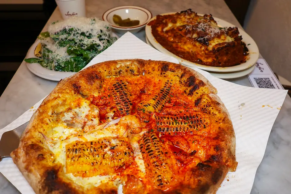 Menu board for pizza and lasagna orders at Low Five Anguk