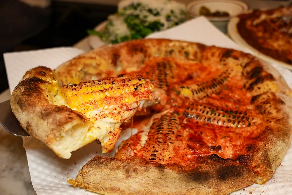 Golden-charred edge of the wood-fired pizza crust