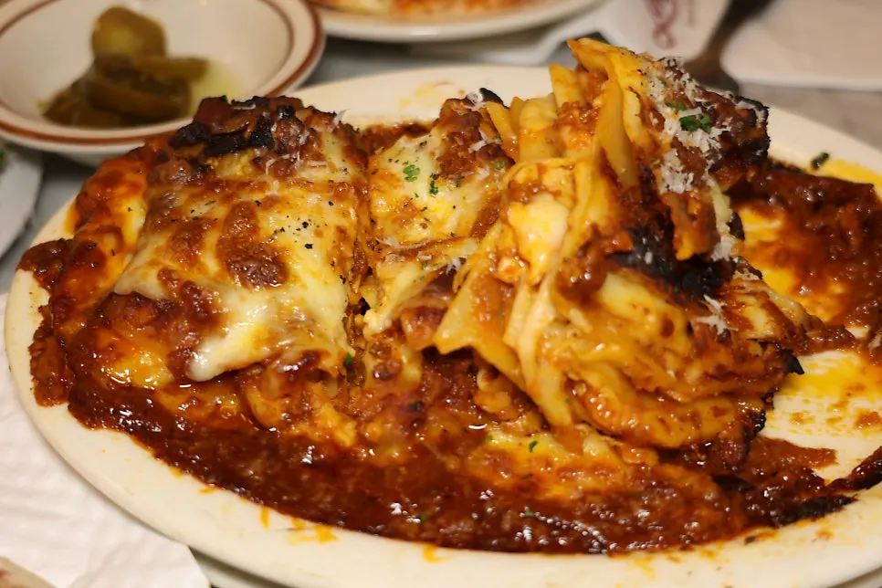 Plate of lasagna with tomato ragù sauce