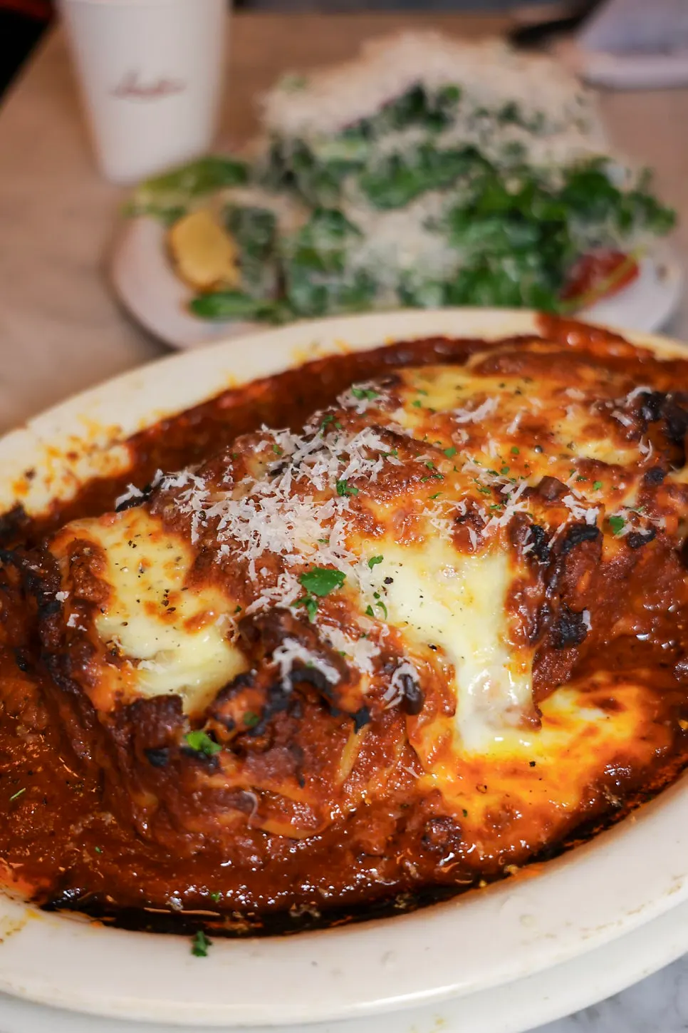 Vertical shot of a lifted slice of lasagna