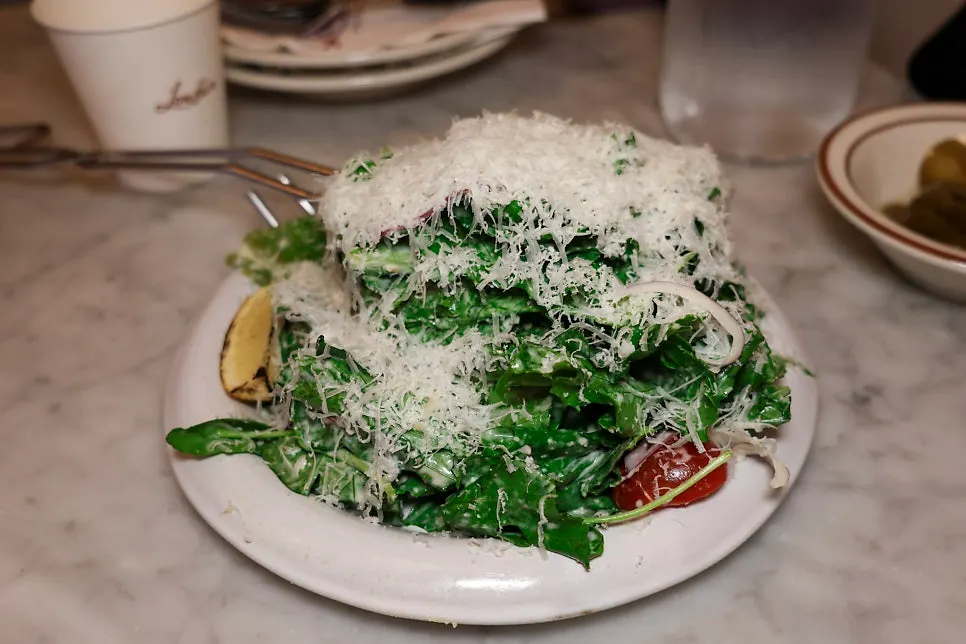 Classic Caesar salad heaped with grated cheese