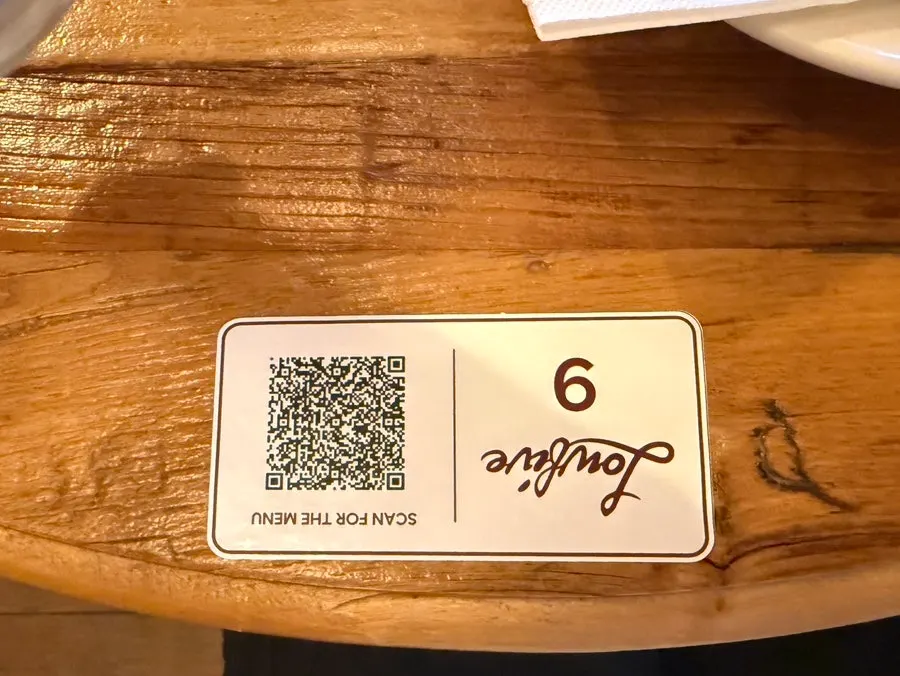 QR code ordering guide and paper menu on the table