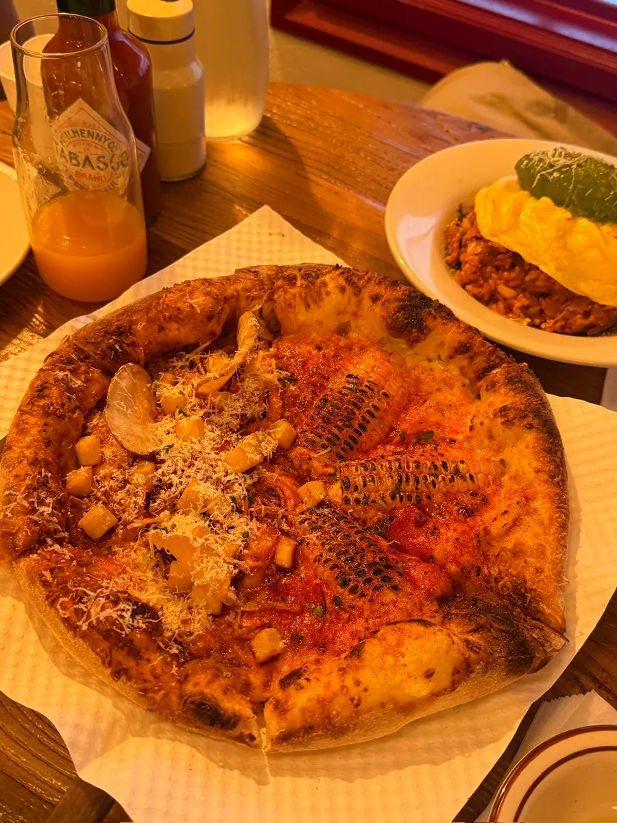 Half-and-half wood-fired pizza with corn and hot chili potato