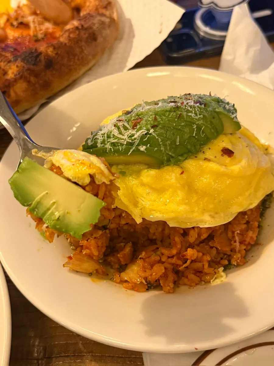 A spoonful of avocado kimchi fried rice