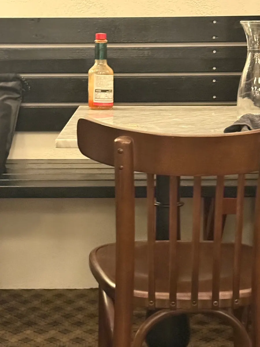 A two-person table by an open window