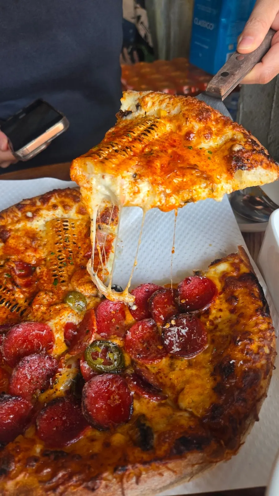Pizza slice served with pickles