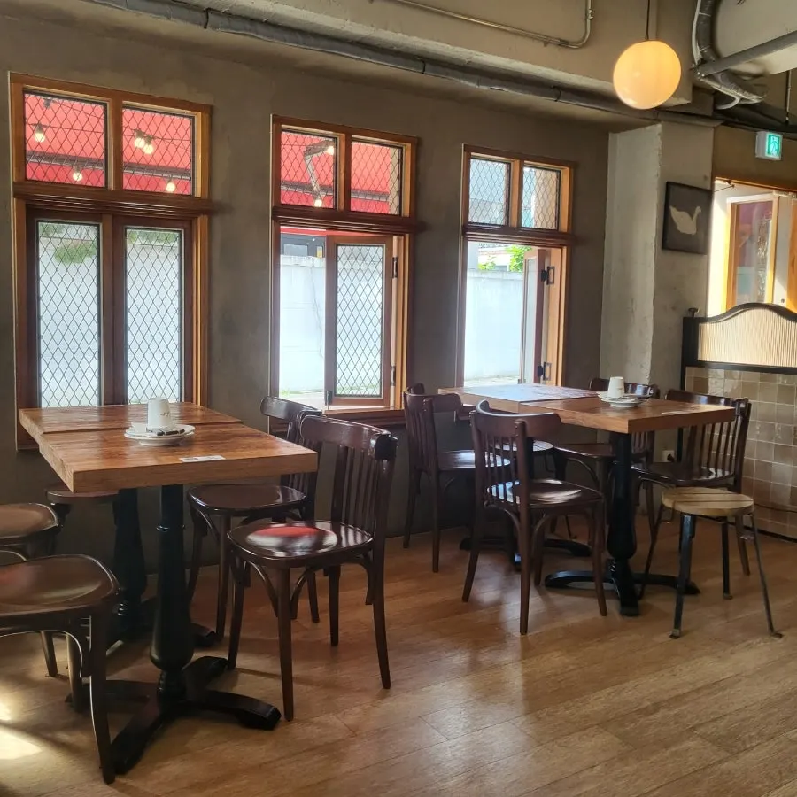 Round two-person tables inside the restaurant