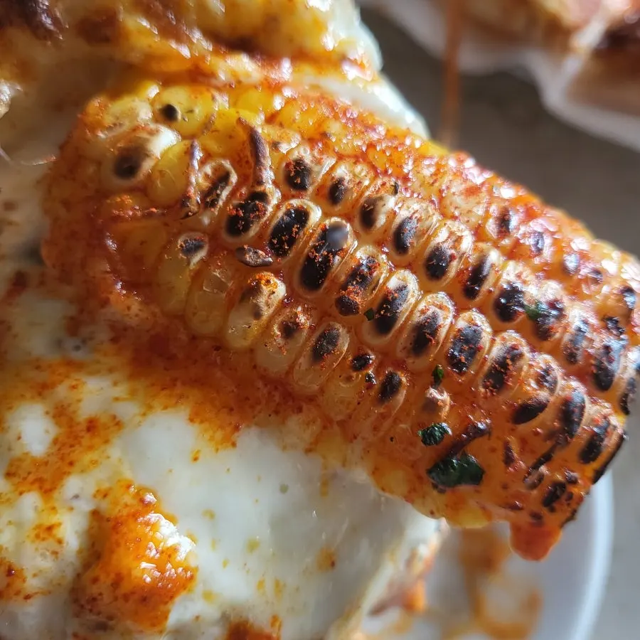 Corn pizza showing chili shrimp and butter seasoning