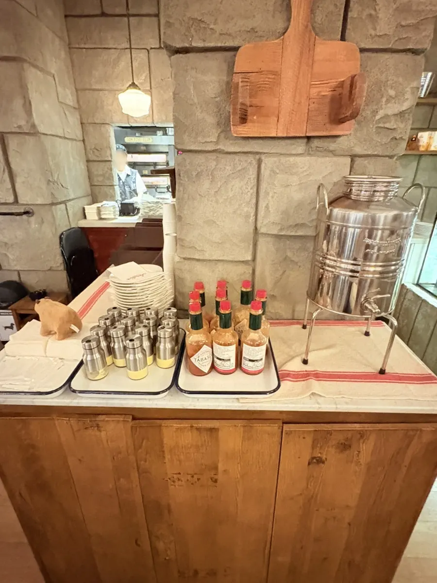 Sauces and bowls set up at the self-serve bar by the kitchen