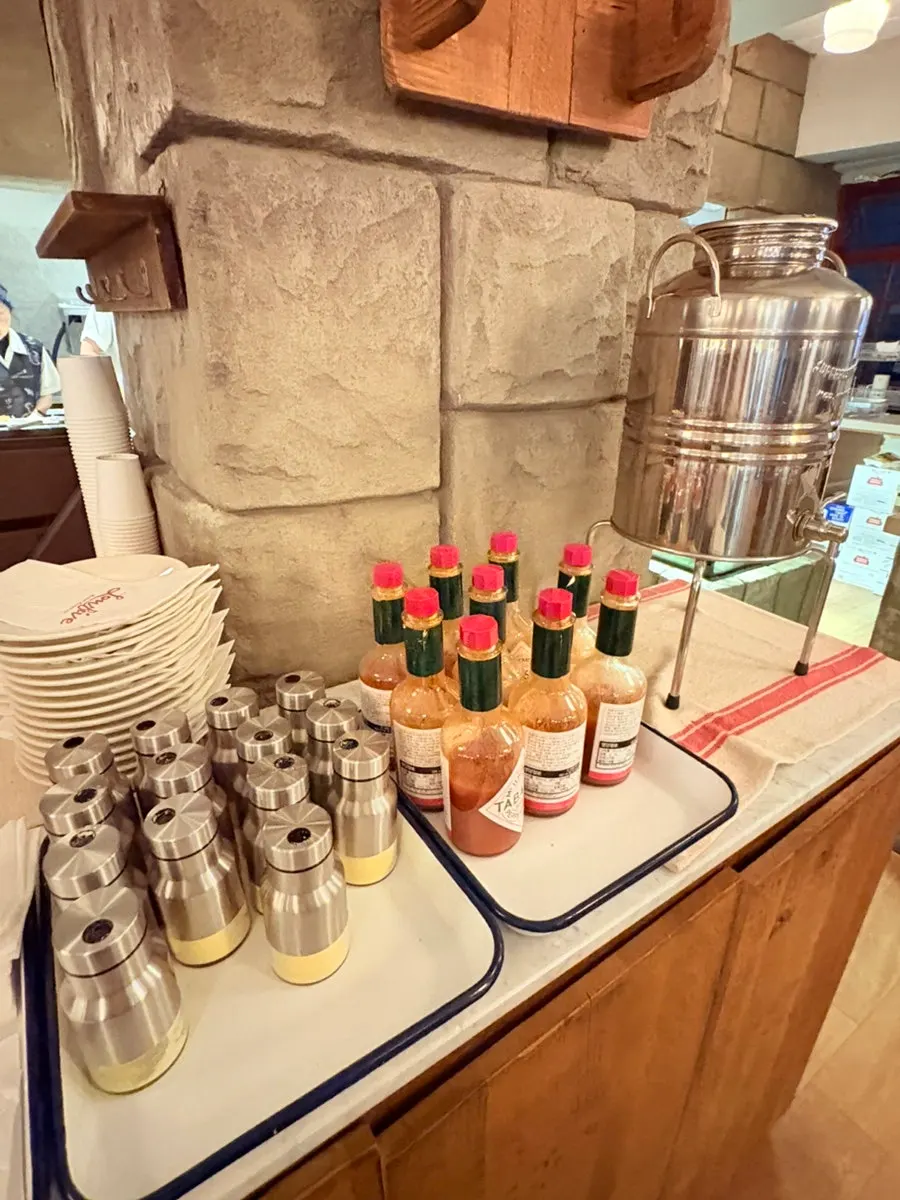 Hot sauce and cheese sauce on the self-serve bar