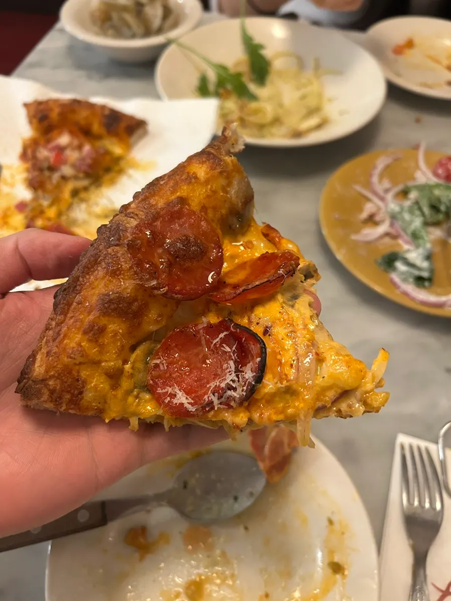Hot pepperoni pizza topped with pepperoni and jalapeños