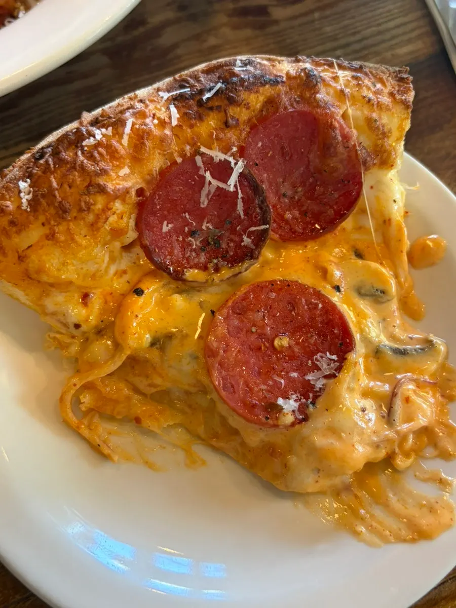 Pizza served alongside other dishes on the table