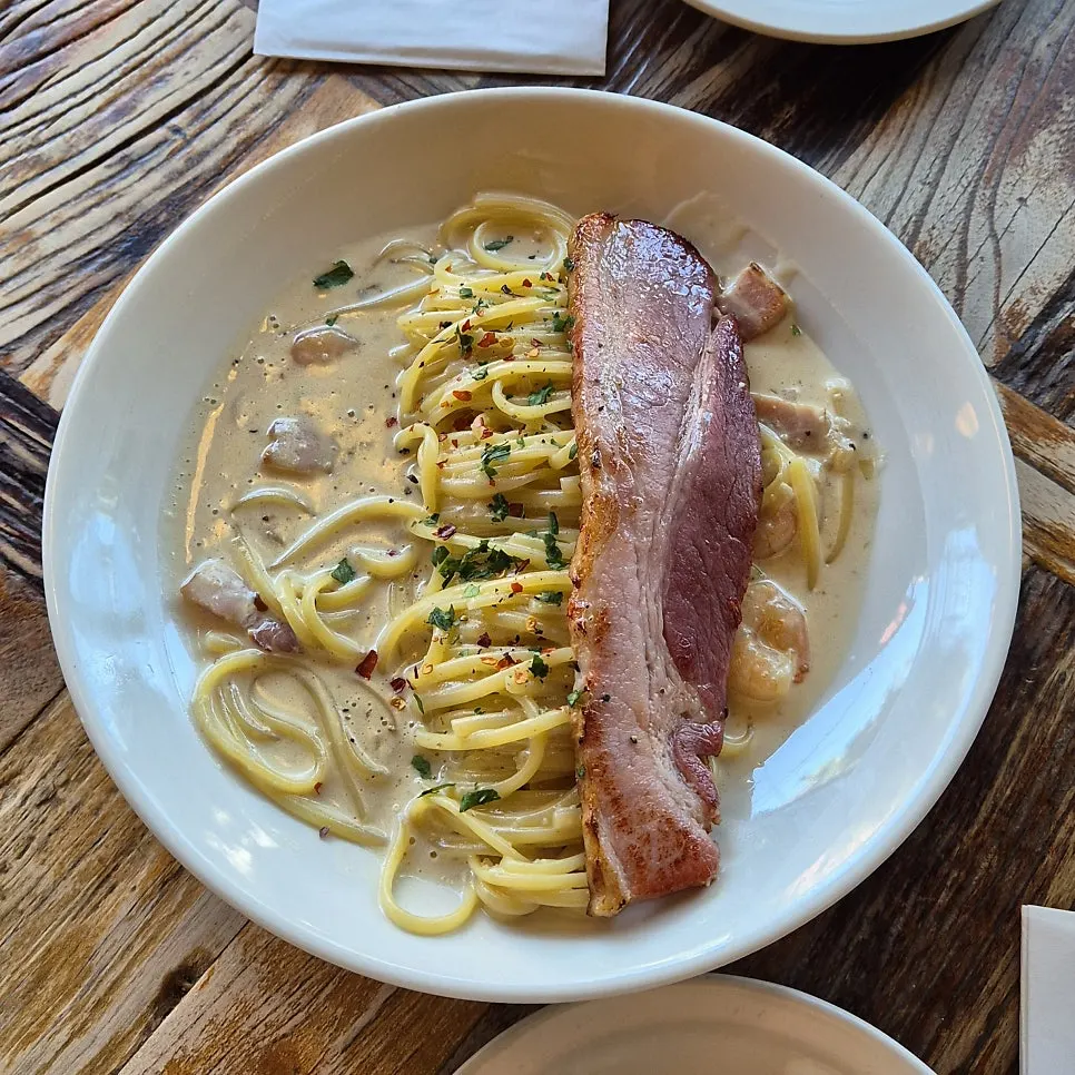A generous spread of pizza and pasta for two