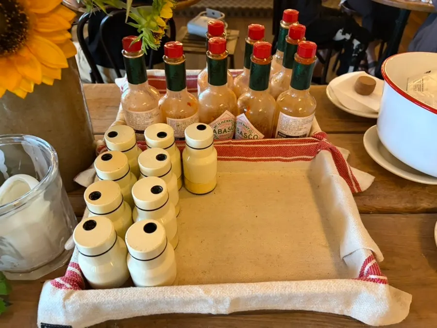 Self-service corner with hot sauce and cutlery