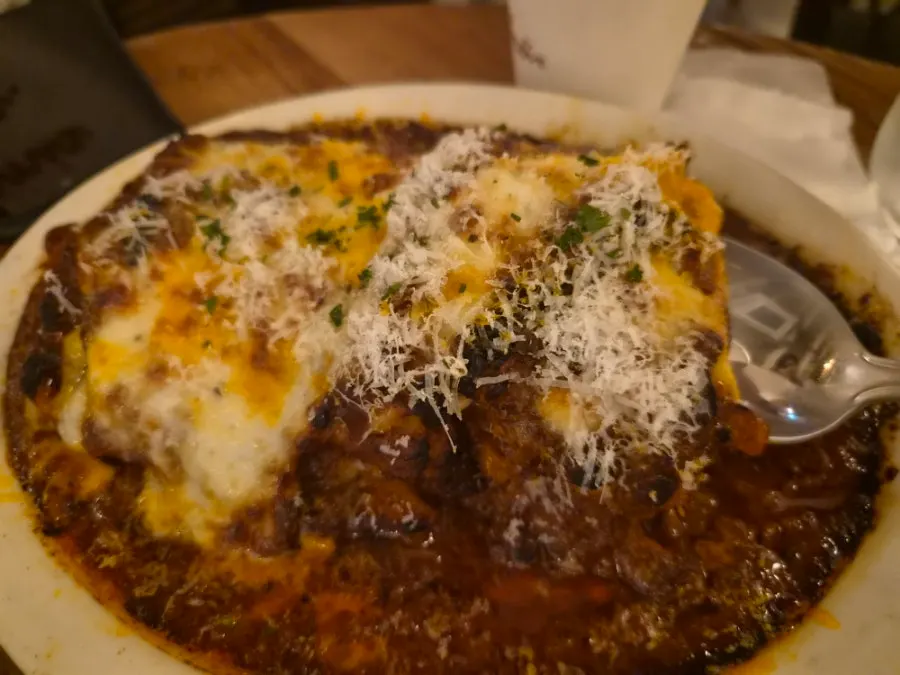 A spoonful taken out of the lasagna