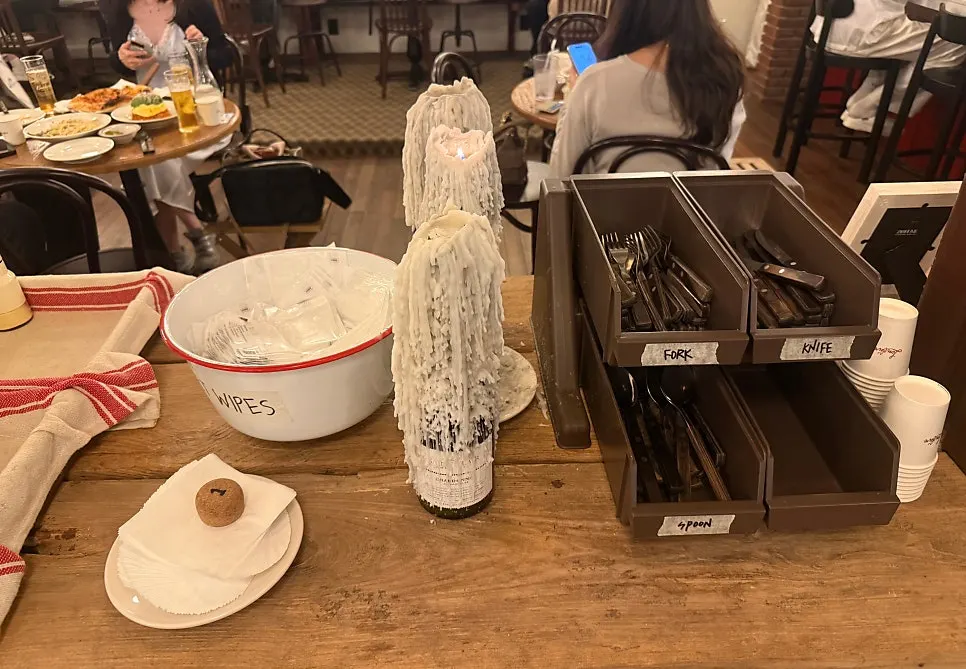 Self-serve station with Tabasco and grated cheese