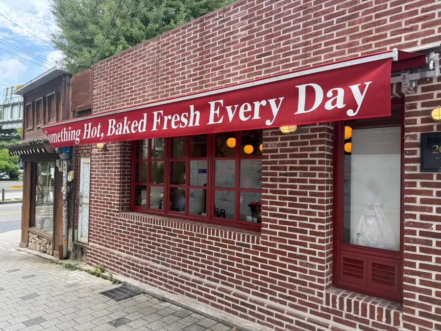 Low Five Anguk exterior with red awning and red brick