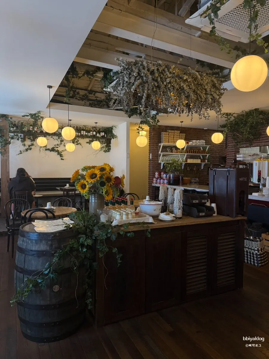 Low Five Anguk interior decorated with plants and flowers