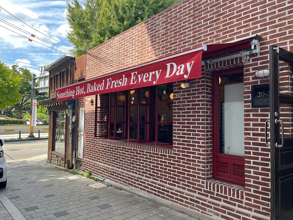 Exterior of Low Five Anguk with red brick facade