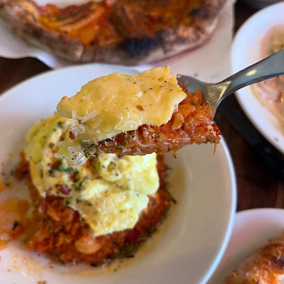 Close-up of kimchi fried rice topped with fluffy egg