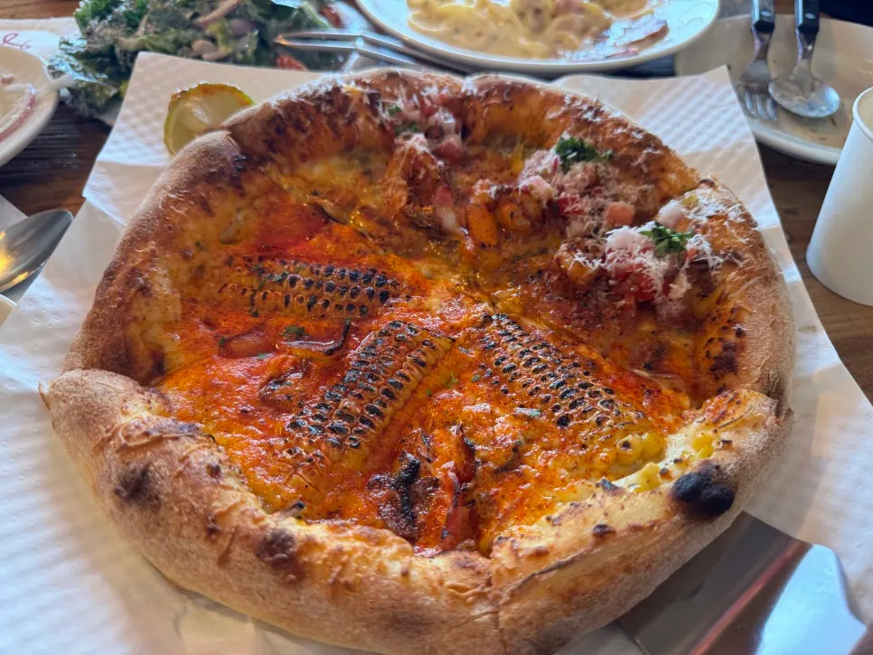 Half-and-half pizza with corn and taco