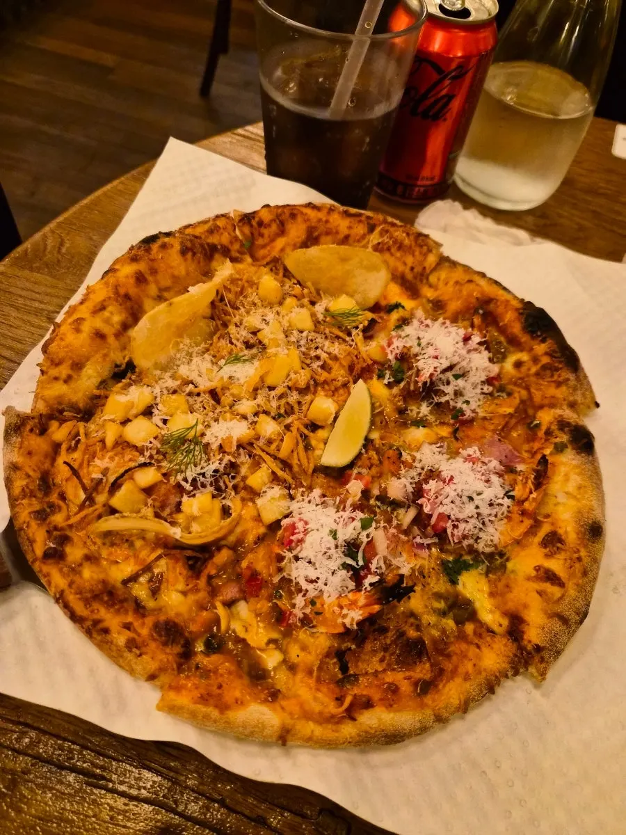 Whole half-and-half pizza set on the table