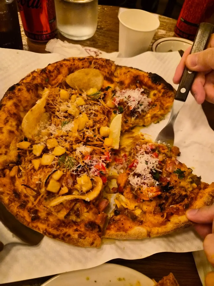 Picking up a slice of the taco pizza