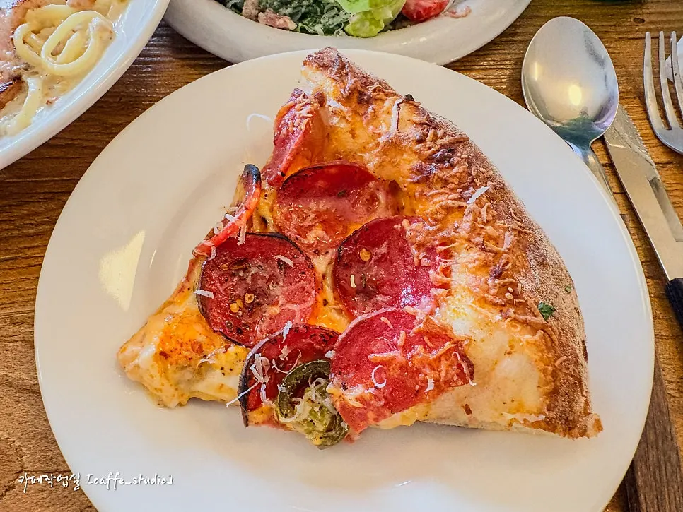 Slice of corn pizza packed with corn kernels