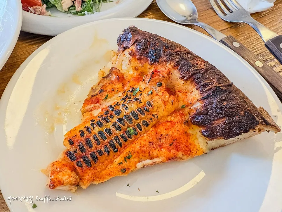 A slice of the half-and-half pizza lifted up