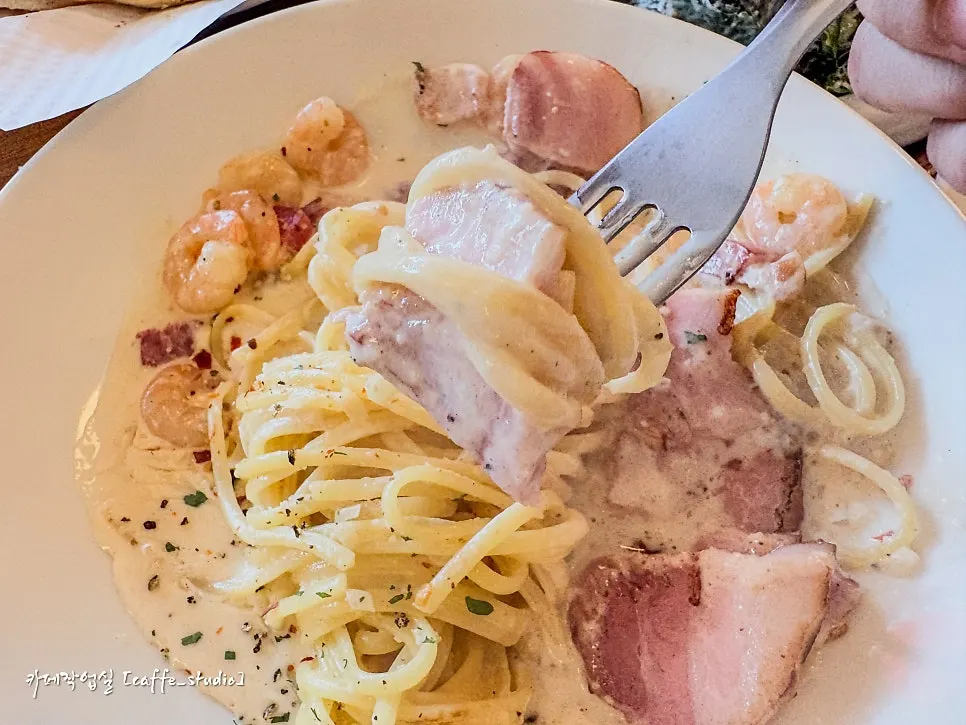Thick cream pasta noodles lifted with a fork