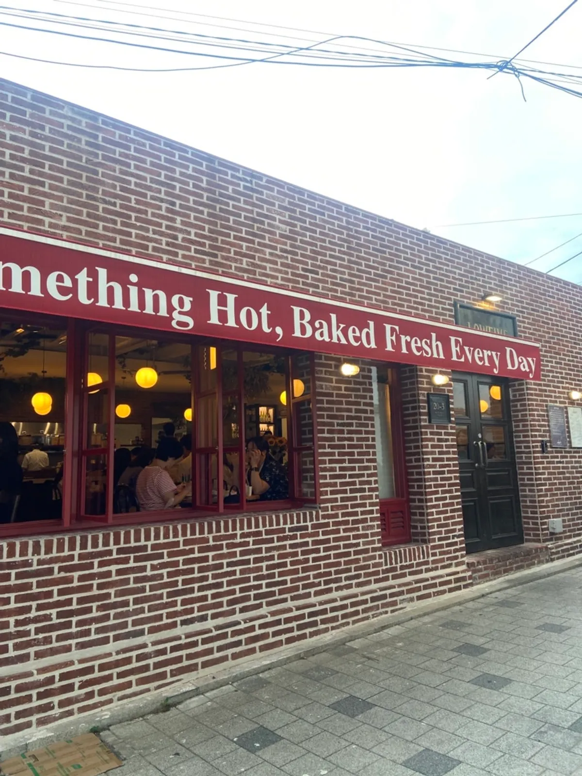 Red brick exterior of Low Five Anguk