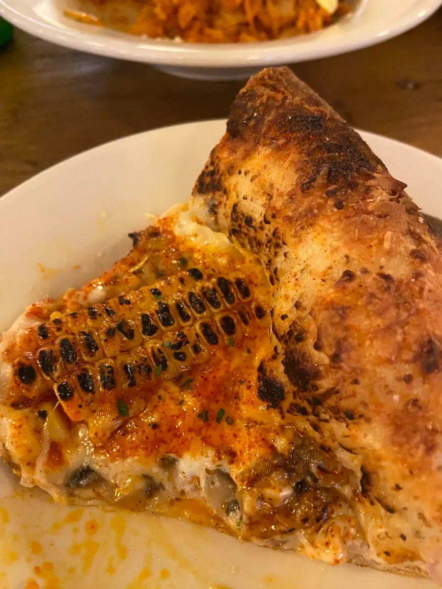 Table spread of pizza, pasta and kimchi fried rice