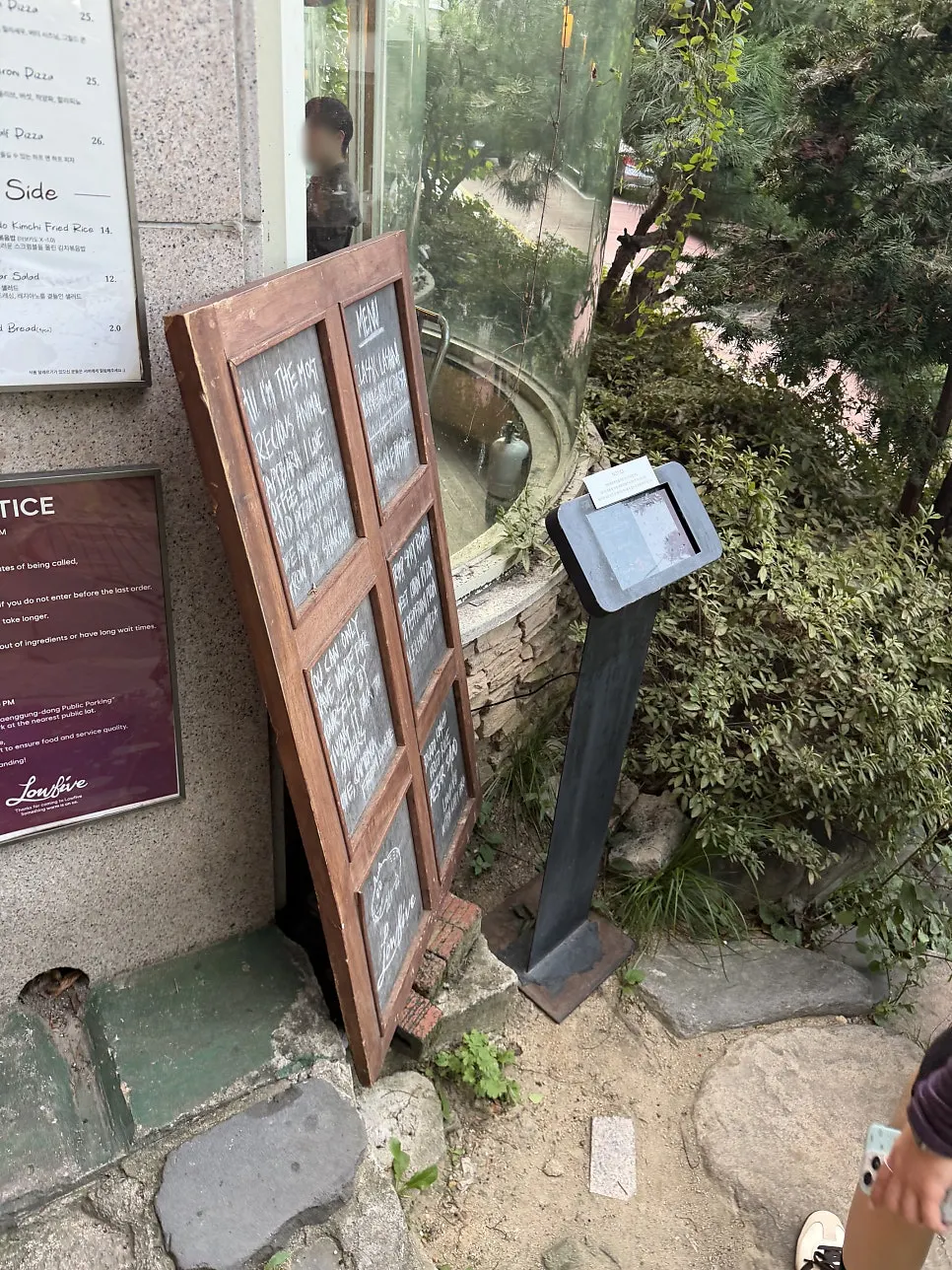 Store entrance with Low Five's hours posted